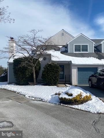 a front view of a house with a yard and parking space