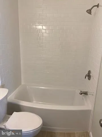 a bathroom with a bathtub and a toilet