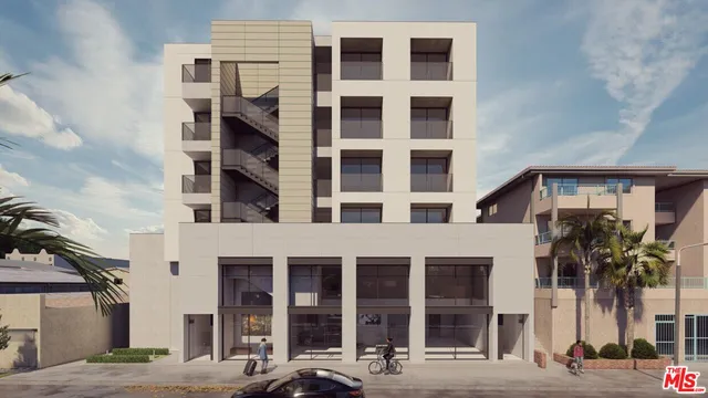 a front view of a building with a tree