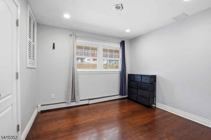 31 Blue Ridge Avenue Green Brook, NJ 08812 - Photo 12 of 28 an empty room with wooden floor and windows
