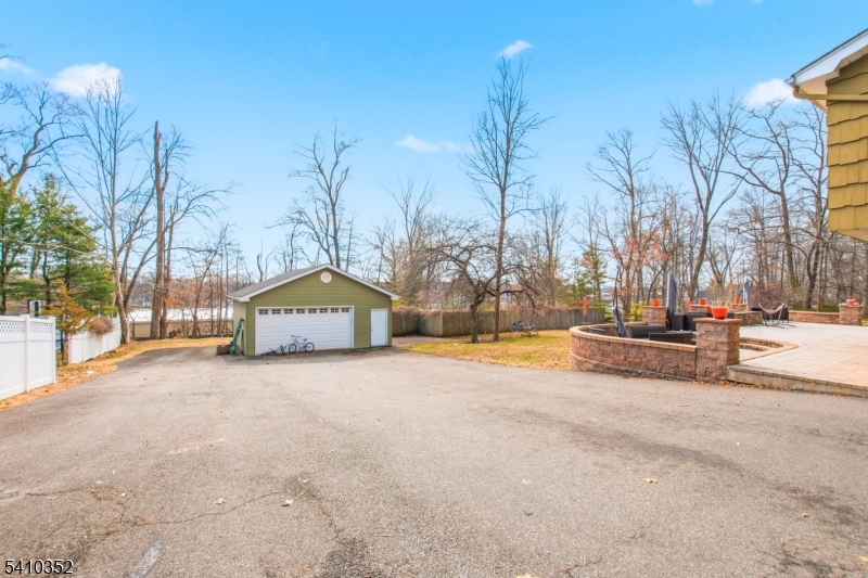 31 Blue Ridge Avenue Green Brook, NJ 08812 - Photo 25 of 28 a view of a large white house with a yard covered with snow in front of house