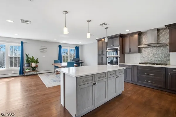 a kitchen with a sink stove and wooden cabinets
