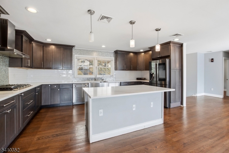31 Blue Ridge Avenue Green Brook, NJ 08812 - Photo 4 of 28 a large kitchen with stainless steel appliances granite countertop a stove a sink dishwasher a refrigerator and a oven with wooden floor
