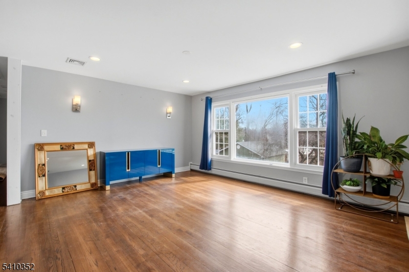 31 Blue Ridge Avenue Green Brook, NJ 08812 - Photo 6 of 28 a view of an empty room with a window and wooden floor