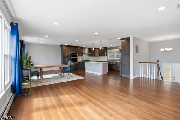 a view of kitchen with kitchen island microwave and stove