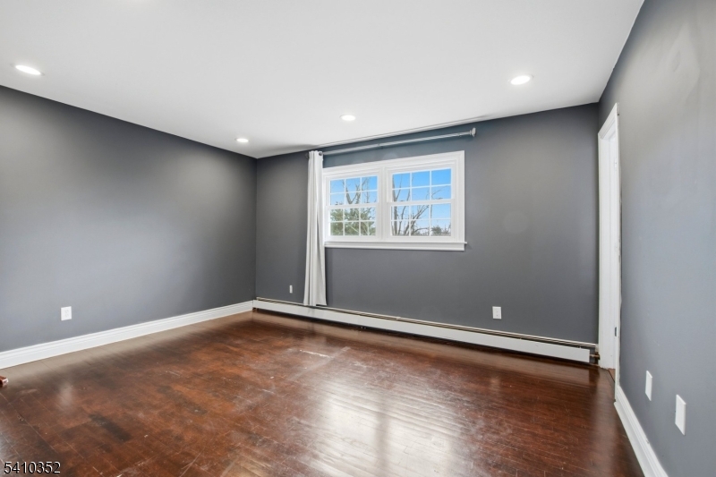31 Blue Ridge Avenue Green Brook, NJ 08812 - Photo 10 of 28 an empty room with wooden floor and windows
