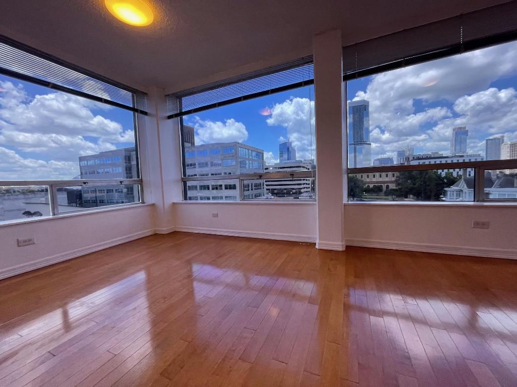 1212 Guadalupe Street, Unit 601 Austin, TX 78701 - Photo 2 of 5 Empty room with a city view and hardwood / wood-style floors