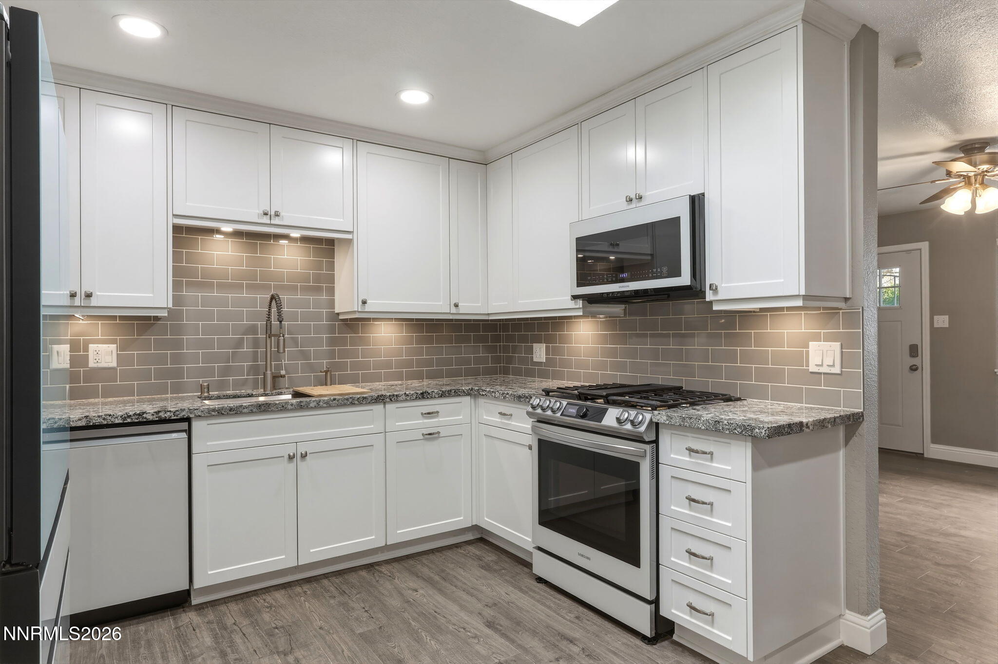 3260 Heights Drive Reno, NV 89503 - Photo 8 of 40 a kitchen with granite countertop a stove sink and cabinets