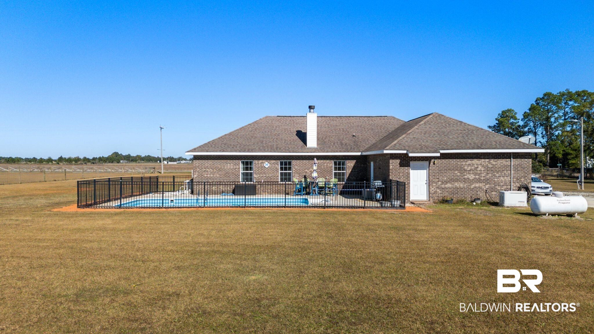 28980 Comstock Road Elberta, AL 36530 - Photo 25 of 38 Back of house featuring a patio area, brick siding, and a chimney