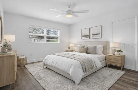 a bedroom with a large bed and a window