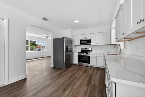 a kitchen with stainless steel appliances a refrigerator and a stove top oven