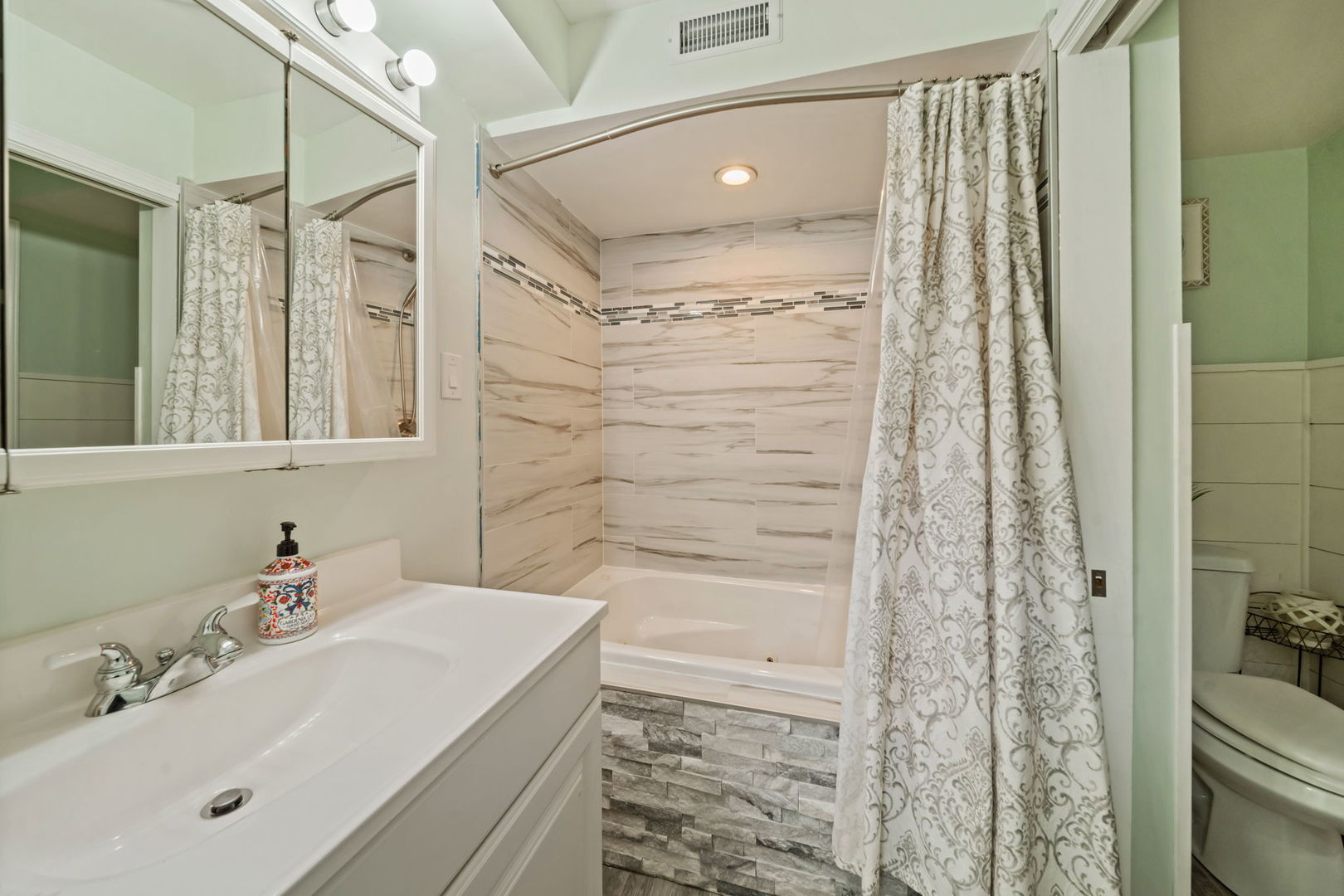 8243 Washington Street Niles, IL 60714 - Photo 19 of 30 a bathroom with a sink and a mirror