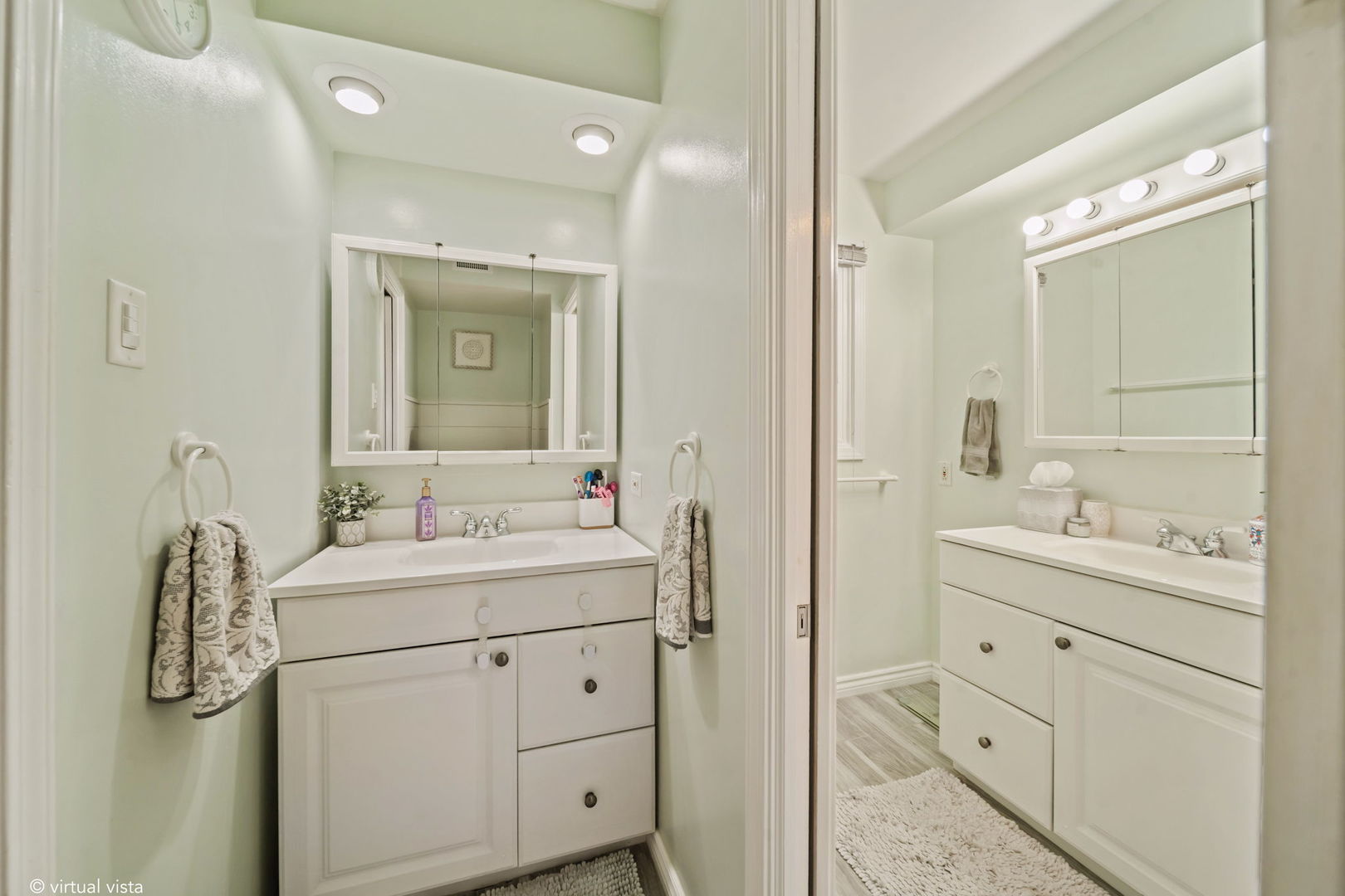 8243 Washington Street Niles, IL 60714 - Photo 20 of 30 a bathroom with a double vanity sink and mirror