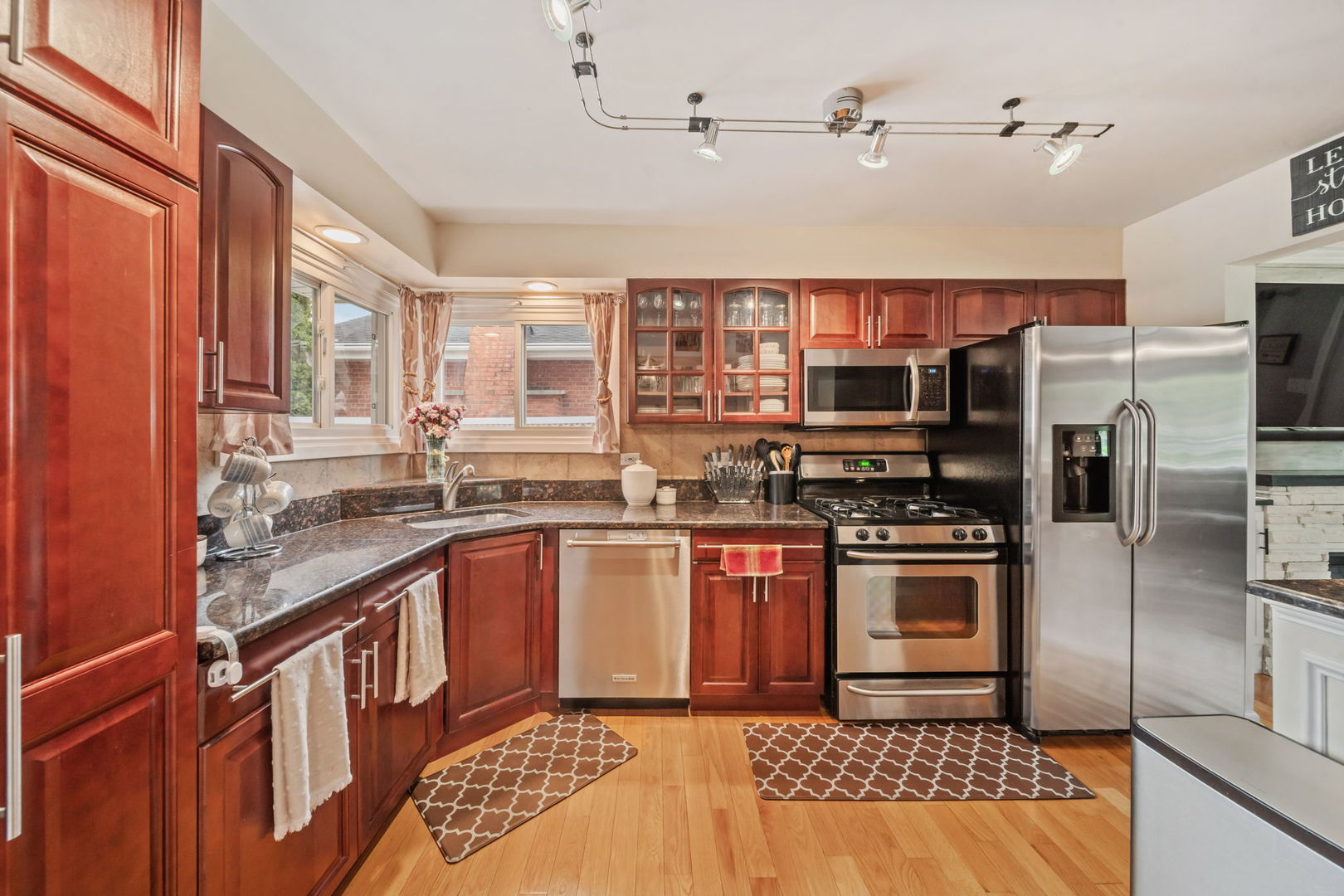 8243 Washington Street Niles, IL 60714 - Photo 2 of 30 a kitchen with stainless steel appliances granite countertop a sink stove and refrigerator