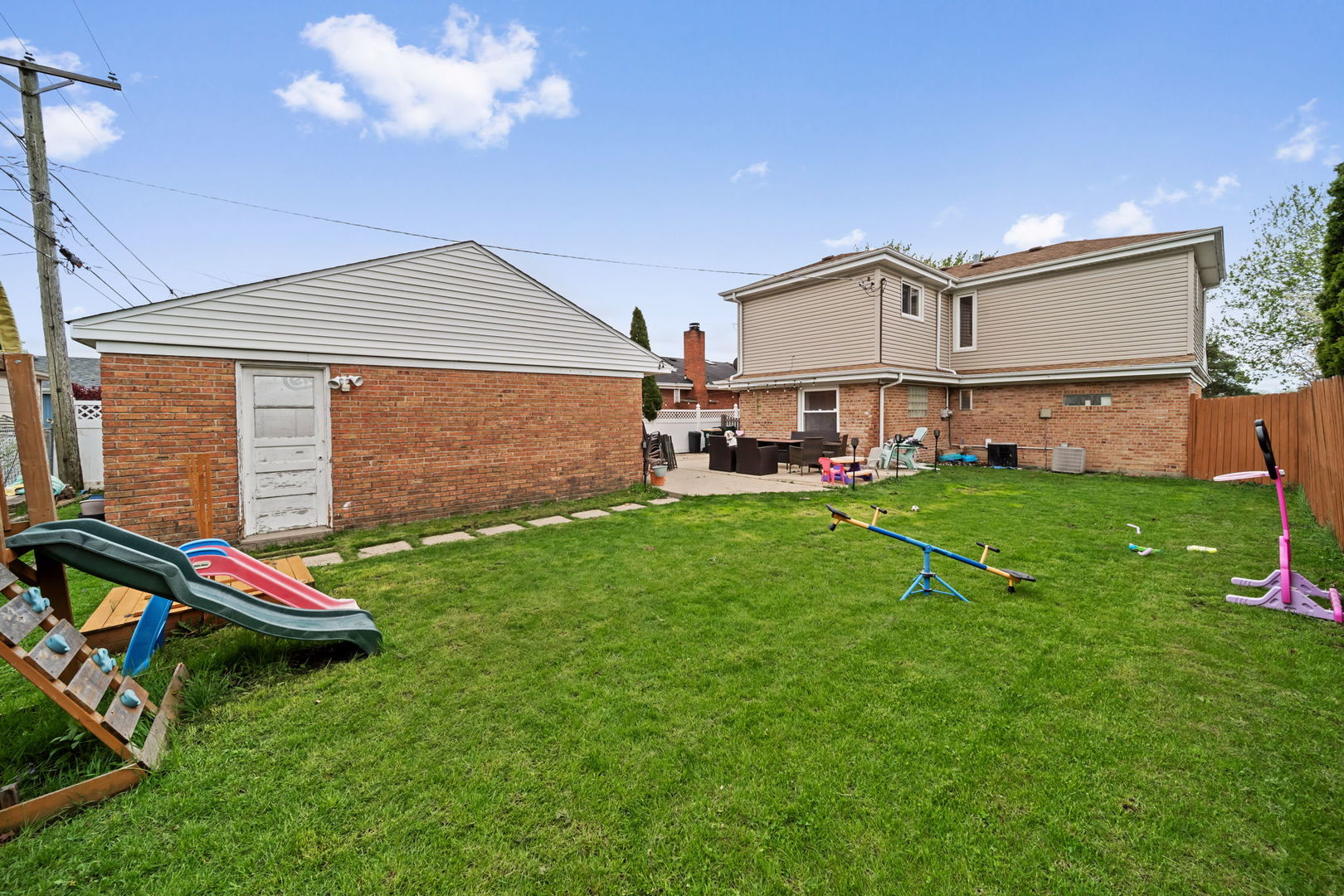 8243 Washington Street Niles, IL 60714 - Photo 23 of 30 a view of a backyard with table and chairs and a barbeque