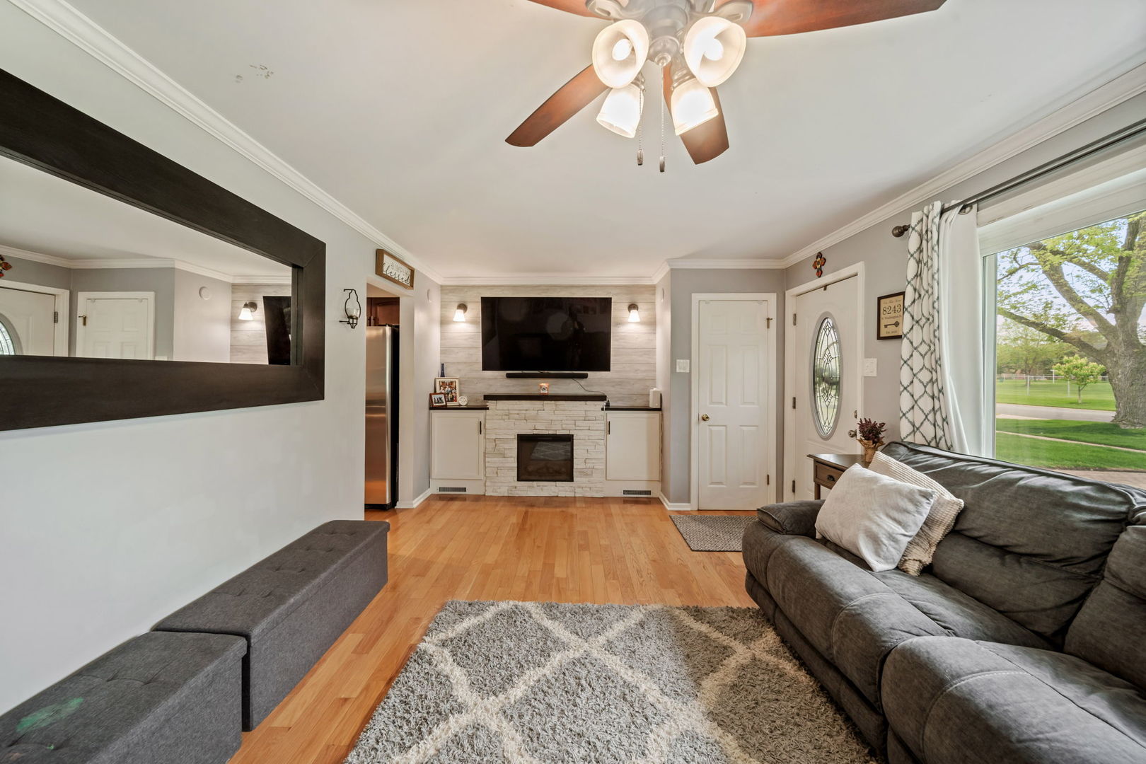 8243 Washington Street Niles, IL 60714 - Photo 5 of 30 a living room with furniture and a flat screen tv