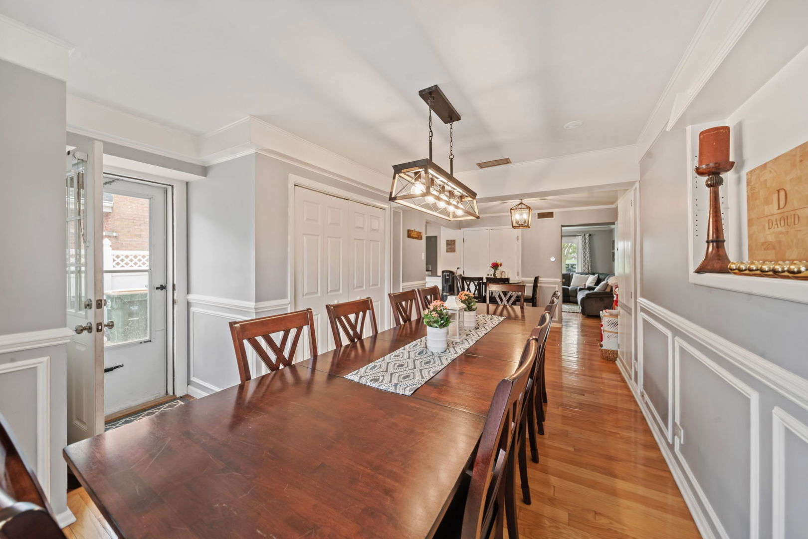 8243 Washington Street Niles, IL 60714 - Photo 7 of 30 a view of a dining room and livingroom with furniture wooden floor a chandelier