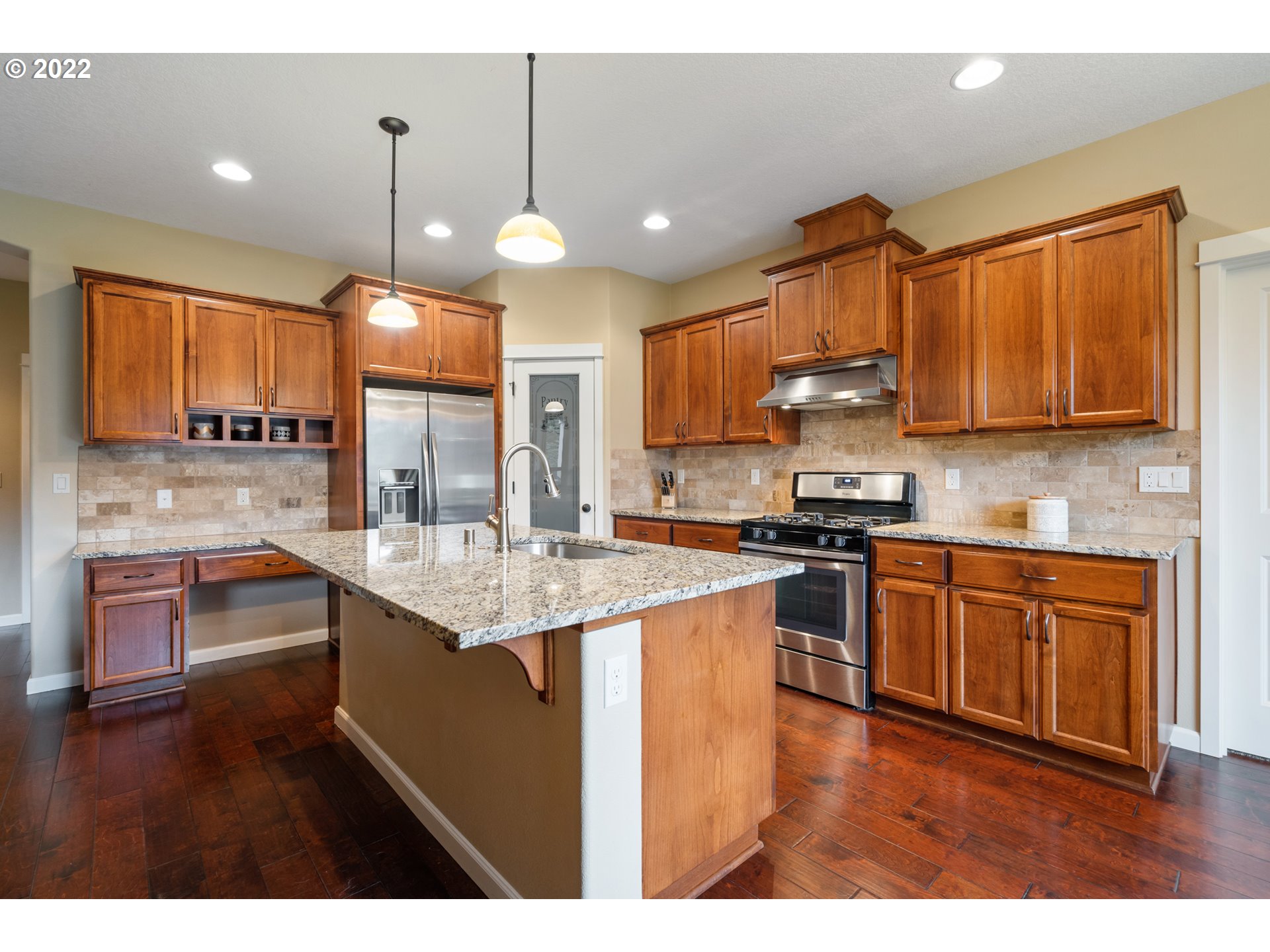 3214 Northeast 171st Street Ridgefield, WA 98642 - Photo 8 of 32 a kitchen with stainless steel appliances granite countertop a sink a stove and a wooden cabinets
