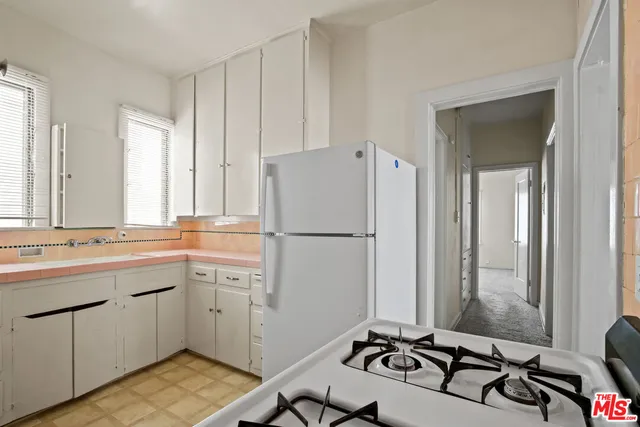 a kitchen with a sink appliances and a window