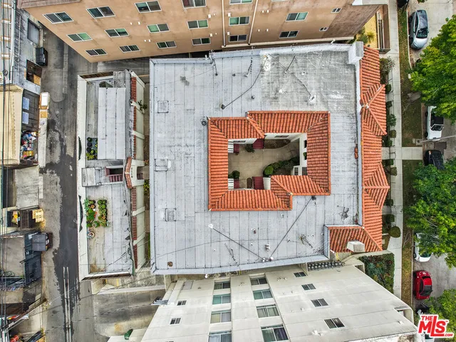an aerial view of a brick building with many windows