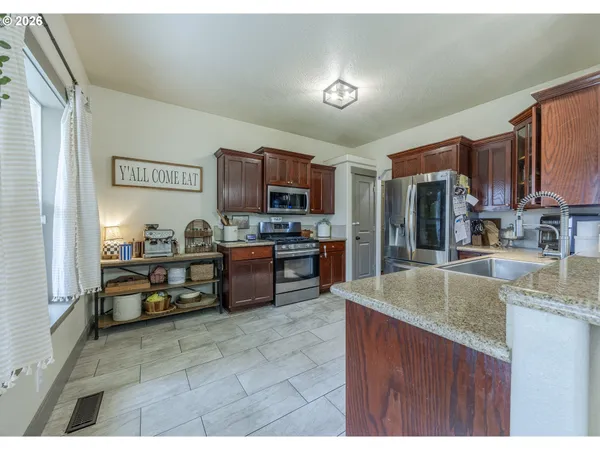 a spacious bathroom with a granite countertop sink mirror and a toilet