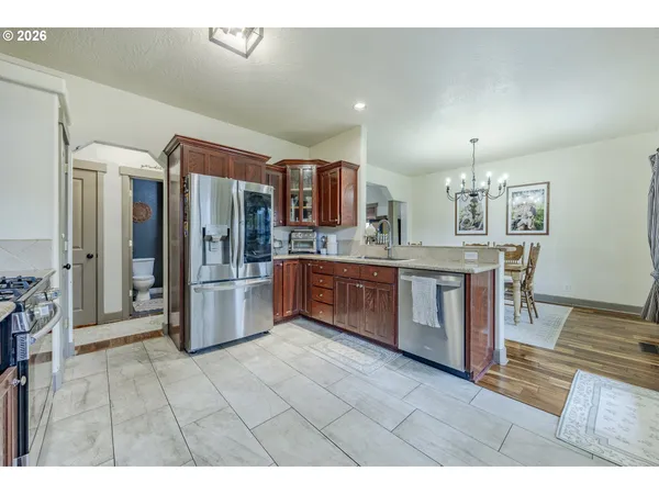a kitchen with granite countertop a stove top oven microwave and cabinets