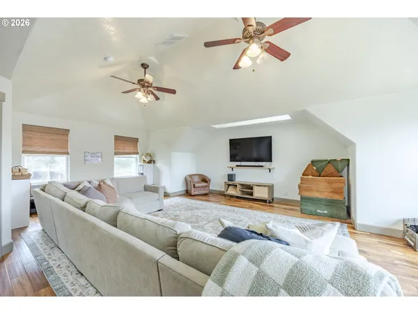 a living room with furniture and a ceiling fan