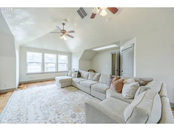a bedroom with a bed lamp and furniture
