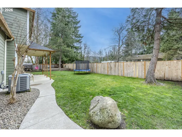 a view of a house with a backyard and a patio