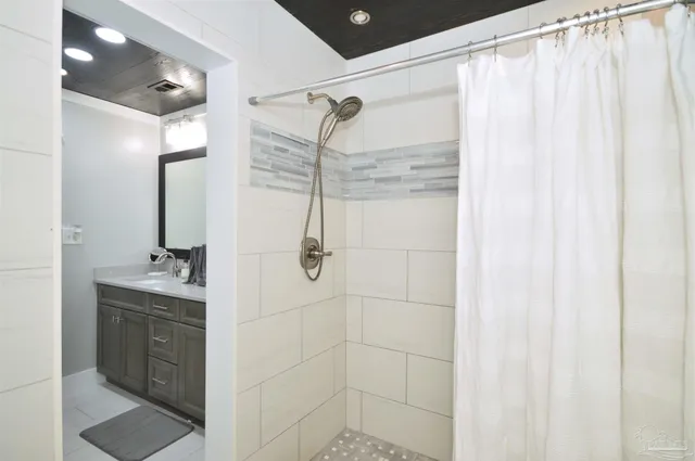 a bathroom with a shower and a sink