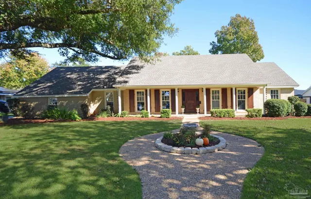 a front view of a house with a yard and porch