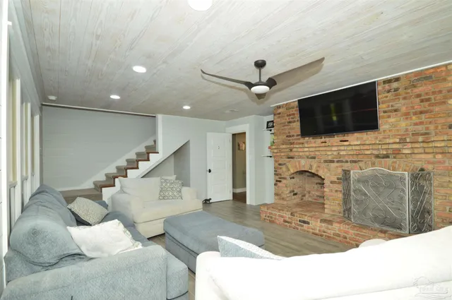 a living room with fireplace a flat screen tv and a fireplace