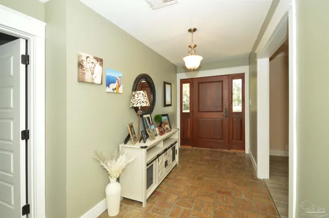 a view of a hallway with entryway wooden floor and front door