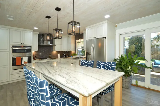 a kitchen with stainless steel appliances granite countertop counter space and wooden floor