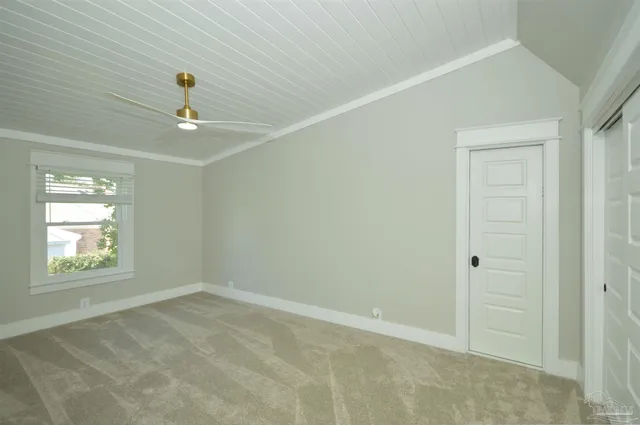 an empty room with windows and closet