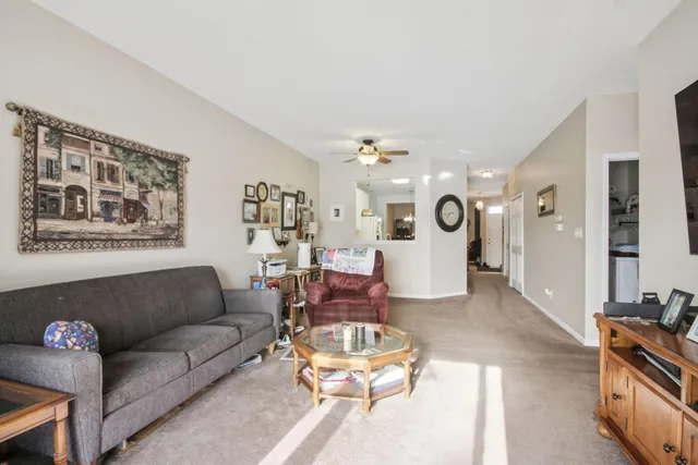 a living room with furniture and kitchen view