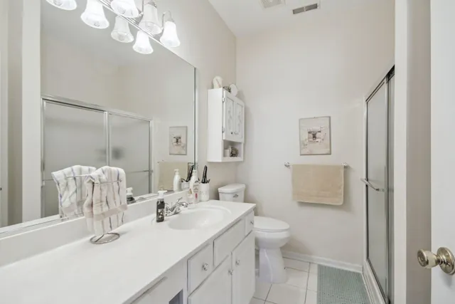 a bathroom with a double vanity sink mirror and toilet