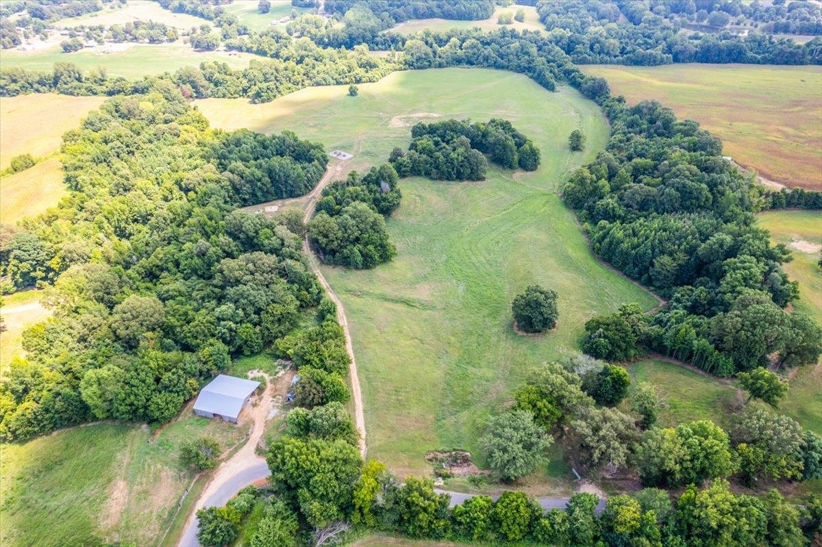1040 Barlow Road Ripley, TN 38063 - Photo 3 of 35 an aerial view of residential houses with outdoor space and lake view
