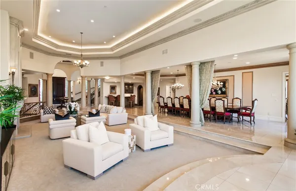 a front view of a house with a yard and potted plants