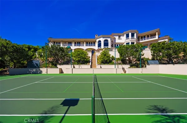 a living room with furniture a fireplace and a floor to ceiling window