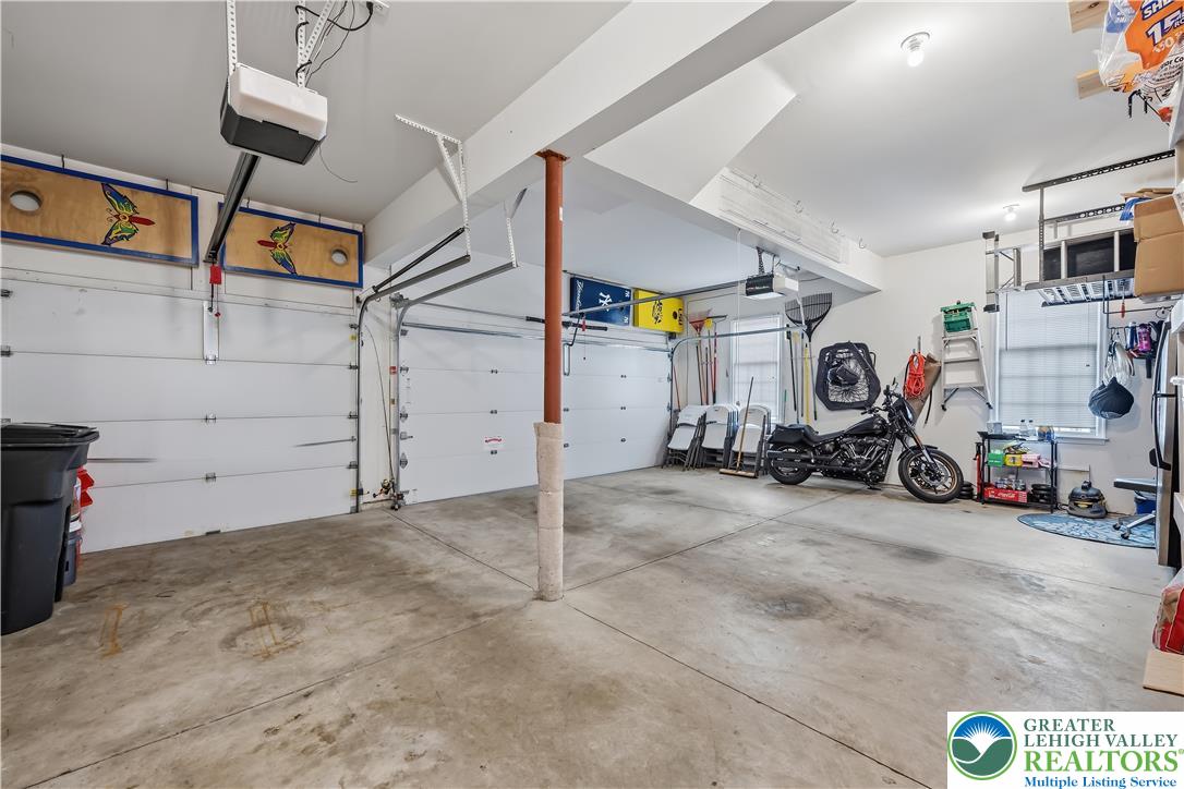 13 Country Road Northampton, PA 18067 - Photo 33 of 71 A spacious garage features ample room for vehicles and storage, with durable concrete flooring and automatic door openers.