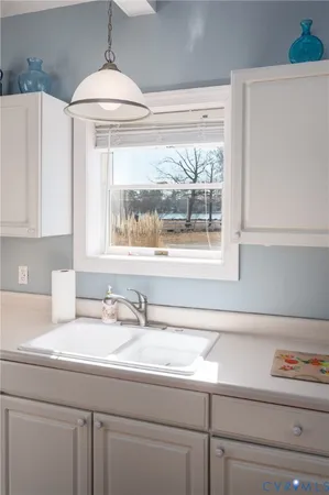 a bathroom with a sink and a window