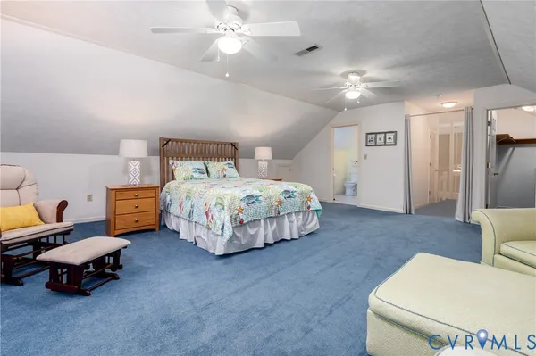 a bedroom with bed and a chandelier