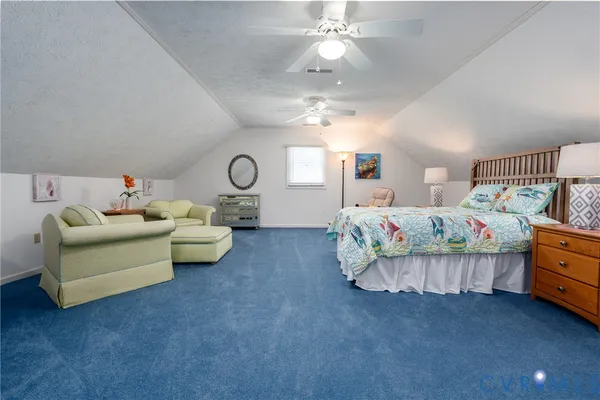 a bedroom with furniture and a chandelier