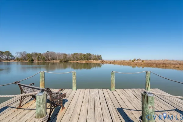 a view of a lake with couches chairs