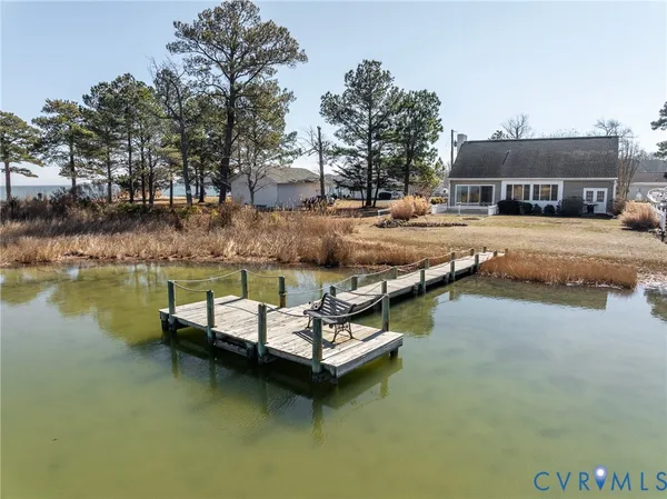 a swimming pool with outdoor seating and lake view