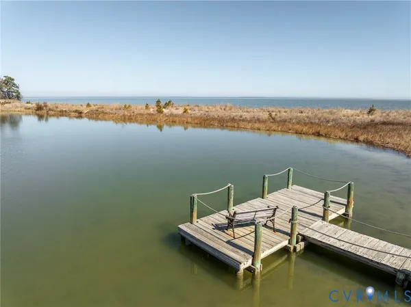a view of a lake with chairs
