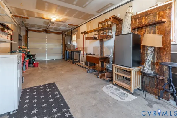 a view of a storage room with water heater and wooden shelves