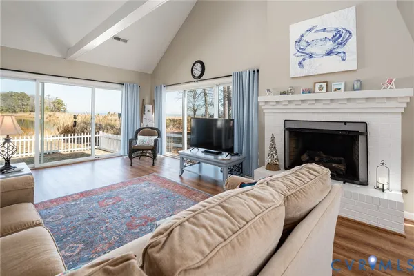 a living room with furniture large window and a fireplace