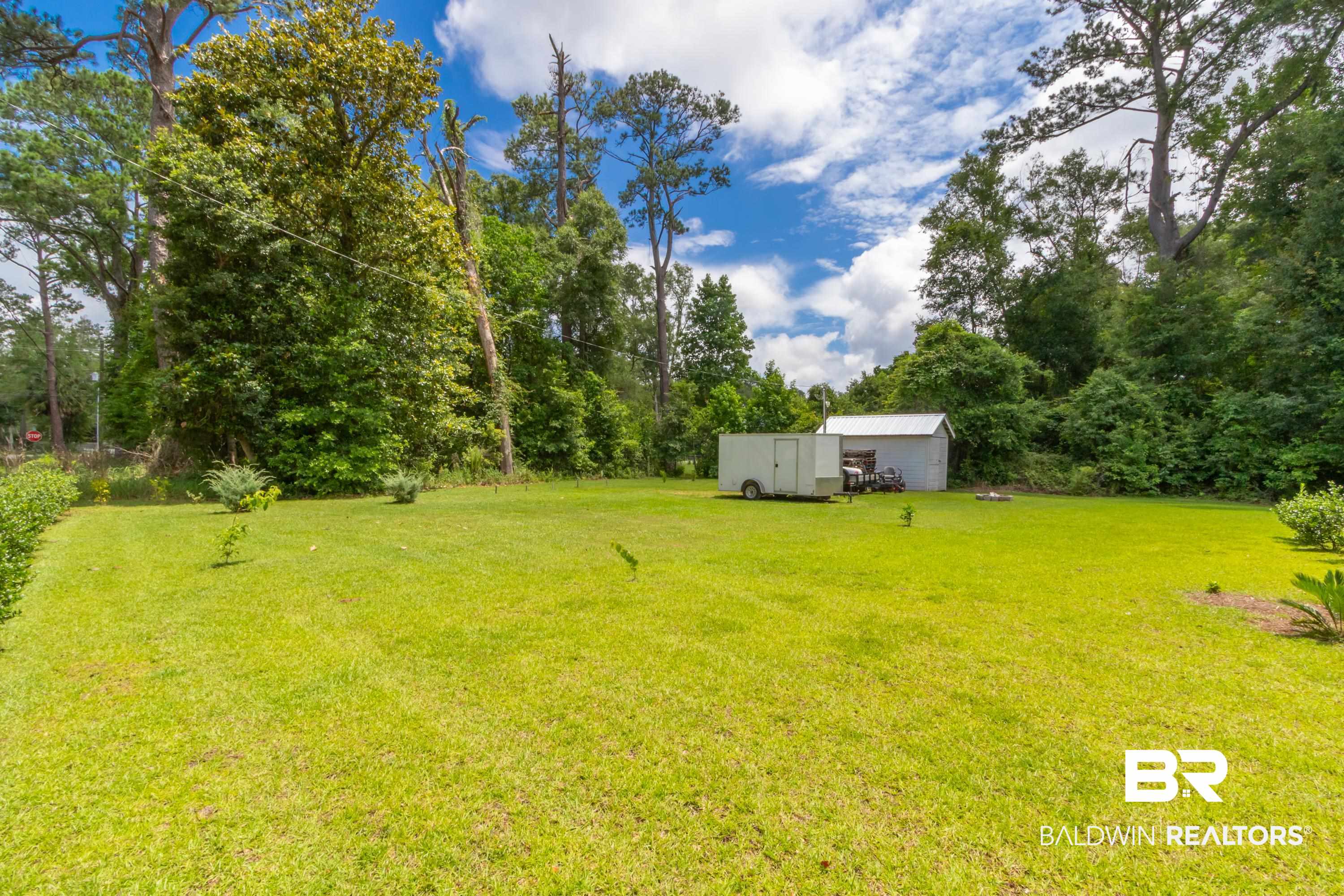 7472 Coopers Landing Road Foley, AL 36535 - Photo 29 of 40 Expansive grassy lawn surrounded by mature trees